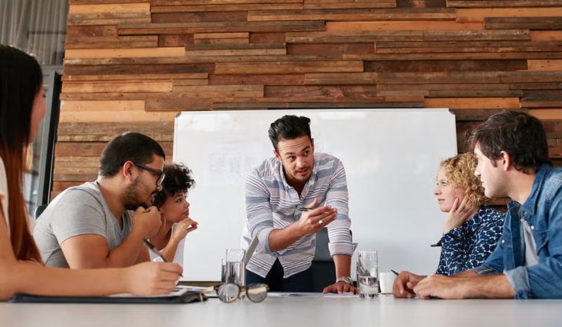 A group of professionals having a discussion in a modern office.